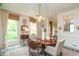 Inviting dining room featuring large windows, neutral walls, and an elegant chandelier at 232 S Audubon Rd, Indianapolis, IN 46219