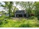 Three-car garage surrounded by lush trees and greenery, providing ample parking and storage space at 232 S Audubon Rd, Indianapolis, IN 46219