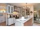 Bright kitchen featuring a spacious island, stainless steel appliances, and detailed cabinetry at 232 S Audubon Rd, Indianapolis, IN 46219