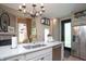 Bright kitchen with stainless steel appliances, white countertops, and a view of the decorative fireplace at 232 S Audubon Rd, Indianapolis, IN 46219