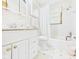 Well-lit bathroom features a shower and tub combination, with a white vanity and patterned floors at 25 N Mustin Dr, Anderson, IN 46012