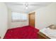 Bedroom with red carpet, a ceiling fan, and natural light from the window at 25 N Mustin Dr, Anderson, IN 46012