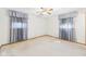 Comfortable bedroom with ceiling fan, large windows with blinds, and neutral decor at 25 N Mustin Dr, Anderson, IN 46012