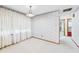Bright dining room with white walls, a chandelier, and light-colored carpeting at 25 N Mustin Dr, Anderson, IN 46012