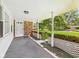 Inviting covered front porch featuring brick accents and classic white columns at 25 N Mustin Dr, Anderson, IN 46012
