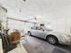 Garage with a parked car and storage space at 25 N Mustin Dr, Anderson, IN 46012