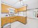 Kitchen with oak cabinets, white countertops, double sink, and view of the back yard at 25 N Mustin Dr, Anderson, IN 46012