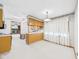 Open-concept kitchen with wood cabinets, white countertops, and adjacent breakfast nook at 25 N Mustin Dr, Anderson, IN 46012