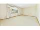 Spacious living room featuring plush carpet and large window with decorative drapes at 25 N Mustin Dr, Anderson, IN 46012