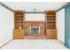 Brick fireplace and built in wooden bookshelves in a carpeted living room at 25 N Mustin Dr, Anderson, IN 46012