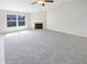 Spacious open-concept living room with a cozy fireplace and neutral carpeting at 2913 Lily Dr, Lebanon, IN 46052