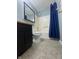 This bathroom features a shower/tub combo and a dark vanity at 3055 Pawnee Dr, Indianapolis, IN 46235