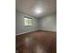 This bedroom features wood-look floors and a window providing natural light at 3055 Pawnee Dr, Indianapolis, IN 46235