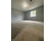 This bedroom offers new carpet and a window providing natural light at 3055 Pawnee Dr, Indianapolis, IN 46235