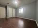 The bedroom has gray walls and wood-look floors, offering a calm and inviting space at 3055 Pawnee Dr, Indianapolis, IN 46235