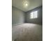 This bedroom offers new carpet and a window providing natural light at 3055 Pawnee Dr, Indianapolis, IN 46235