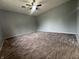 Neutral bedroom with ceiling fan and patterned carpet at 3055 Pawnee Dr, Indianapolis, IN 46235