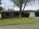 Charming single-story brick home featuring a well-maintained lawn and an attached one car garage at 3055 Pawnee Dr, Indianapolis, IN 46235