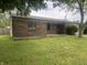 Brick single story house with front yard and landscaping. Windows and entryway visible at 3055 Pawnee Dr, Indianapolis, IN 46235