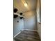 Laundry room with wood-look flooring, shelves and a door at 3055 Pawnee Dr, Indianapolis, IN 46235