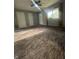 Spacious living room with ceiling fan, plush carpet, and a sunlit window at 3055 Pawnee Dr, Indianapolis, IN 46235