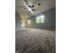 Living room featuring patterned carpet, neutral walls, and windows at 3055 Pawnee Dr, Indianapolis, IN 46235