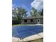 Backyard pool with a dark cover on a bright day at 3055 Pawnee Dr, Indianapolis, IN 46235