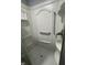 This shower features chrome fixtures, built-in shelving, and a grab bar at 3055 Pawnee Dr, Indianapolis, IN 46235