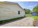 View of the backyard with a small storage shed, some greenery, and the home's exterior at 3072 Falcon Dr, Indianapolis, IN 46222
