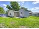 Spacious backyard features lush grass, a shed, and partial fencing at 3072 Falcon Dr, Indianapolis, IN 46222