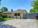 Charming yellow home with gravel driveway and well-maintained lawn at 3072 Falcon Dr, Indianapolis, IN 46222