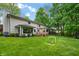 Spacious backyard with deck, pergola, and lush lawn perfect for outdoor entertaining and recreation at 3230 Amherst St, Indianapolis, IN 46268