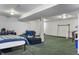 Large basement area with carpeting, exposed beams, and ample open space for flexible use at 3230 Amherst St, Indianapolis, IN 46268