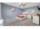 Charming bedroom featuring plush carpet, a ceiling fan, and stylish decor for a cozy retreat at 3230 Amherst St, Indianapolis, IN 46268