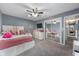 Bright bedroom features a mirrored closet, ceiling fan, neutral walls, and plush carpeting at 3230 Amherst St, Indianapolis, IN 46268