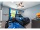 Cozy bedroom with gaming theme, featuring controller rug, ceiling fan, and natural light at 3230 Amherst St, Indianapolis, IN 46268