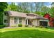 Beautiful exterior view of the home showcasing stone, siding, and landscaped front yard at 3230 Amherst St, Indianapolis, IN 46268