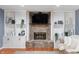 Living room features a stone fireplace with a wooden mantel and built-in shelves on either side at 3230 Amherst St, Indianapolis, IN 46268