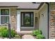 Inviting front entrance with decorative landscaping, featuring a 'Welcome' sign and glass-paneled door at 3230 Amherst St, Indianapolis, IN 46268