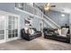 Bright living room with high ceilings, stairs to a loft, carpet flooring and comfortable seating at 3230 Amherst St, Indianapolis, IN 46268