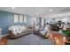 Spacious living room with hardwood floors, comfortable seating, and an open view into the kitchen at 3230 Amherst St, Indianapolis, IN 46268