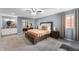 Spacious main bedroom with carpet flooring, a ceiling fan, and an ensuite bathroom at 3230 Amherst St, Indianapolis, IN 46268