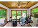 Bright sunroom with wood paneling, tile floors, and views of the backyard at 3230 Amherst St, Indianapolis, IN 46268