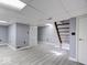 Finished basement offers a versatile space with wood floors, a drop ceiling, and a separate door at 3342 Foltz St, Indianapolis, IN 46221