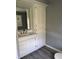 Bathroom featuring a sink with cabinet, mirror, and a tall linen cabinet at 3342 Foltz St, Indianapolis, IN 46221