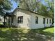 Side view of the home showcasing white brick exterior, trimmed windows, and yard at 3342 Foltz St, Indianapolis, IN 46221