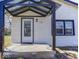 Up-close view of home entrance showing covered porch, glass door, and trimmed windows at 3342 Foltz St, Indianapolis, IN 46221