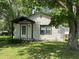 Charming front exterior of home with covered entry and mature trees in a landscaped yard at 3342 Foltz St, Indianapolis, IN 46221