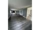 Open concept living space showing kitchen, door to basement, and vinyl floors at 3342 Foltz St, Indianapolis, IN 46221