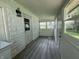 Enclosed porch with stone walls and windows, offers an outdoor living space at 3342 Foltz St, Indianapolis, IN 46221